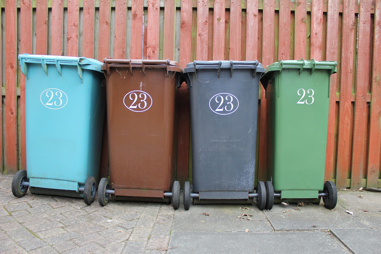 Four coloured wheelie bins.