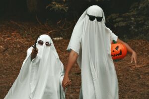 Children in sheets pretending to be ghosts.