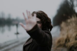 A woman holding out her hand to say, "Stop!"