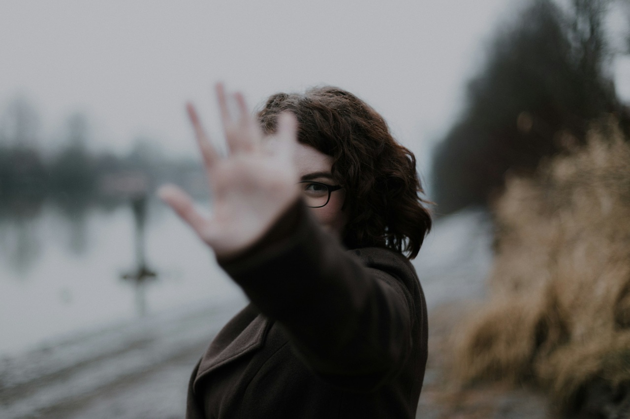 A woman holding out her hand to say, "Stop!"